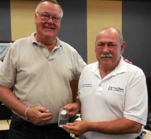 Outgoing CDD 7 Supervisor Niles Getz, left, is presented with a clock in recognition of his six years of service to CDD 7. CDD 7 Chairman Ron McMahon made the presentation.