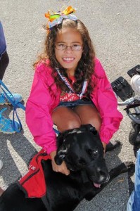 Autism patient Sophia L. received an award with her service dog in training 'Victoria.'