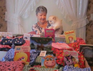 Darleen Gross and Honey her favorite Chow show off the ditty bags, books and pajamas donated to the Silver Trefoils drive.