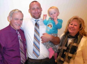 David Shaw holds his 14-month-old daughter. With him are his parents, Terri and Ron Shaw of Deland.