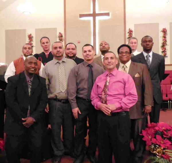 Bishop Samuel Cotto with graduates of the House of Hope program Sunday at New Covenant United Methodist Church.