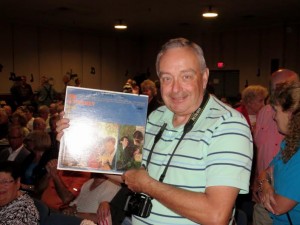 Richard McClintock holds up an old album by The Lettermen.