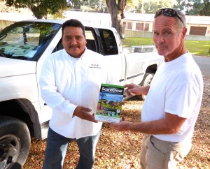FWC contractor Mike Connolly, right, hands a "scarecrow" to Rudy Gonzales. 