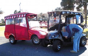 A Villager checks his golf cart for damage following a collision near Turtle Mound golf course.
