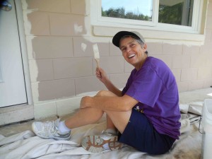 Villager Debbie Diroff helps with painting at House of Hope.