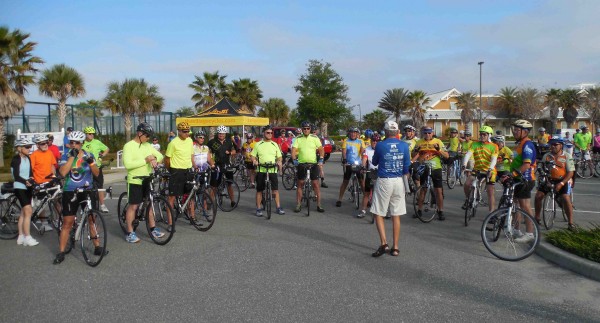 Bicyclists receive final instructions before starting the ride.