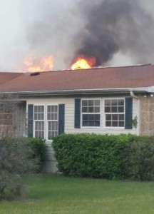 Flames shoot through the roof of this home in Oakland Hills.