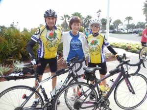 Peg Casey, center, sends off riders Ron and Monique Robitaille.