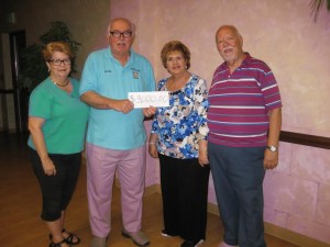 Barbara and Walter Griffith receive a donation from Diana and Joe Arlt of the Showcase of Talent Club