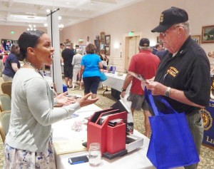 Shannon Antone of the Gainesville VA facility's Fisher House residence program talked with Santiago Villager and Vietnam veteran Bob Vick.