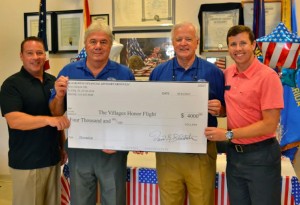 Travis Bender, David Blackston, and Drew Blackston of Blackston Financial & Advisory Group presented Honor Flight's Jerry Lemerise, third from left, with a check for $4,000.