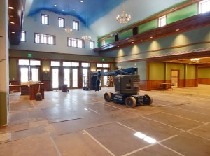 Facing toward the front, the large lobby has tall ceilings and nice fixtures.