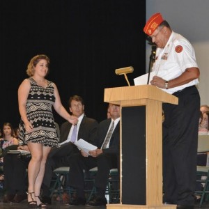 Fred Geier of the Marine Corps League prepares to hand over a scholarship.