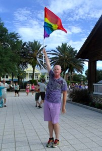 Tim Smith waves a flag Friday at Market Square.
