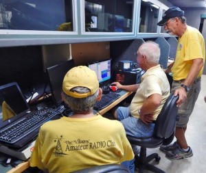 Volunteers Maury Schwartz, Wayne Brown and Pete Stafford, man a Morse code key and new FLEX SDR (software defined radio) technology.