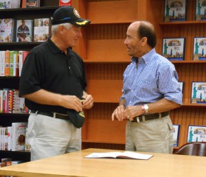 Don Hahnfeldt, left, presents Lee Greenwood with a hat from the USS Tennessee.