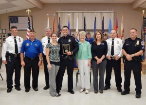 Officer Joshua Higgins, with plaque, was honored by town staff and the mayor. 