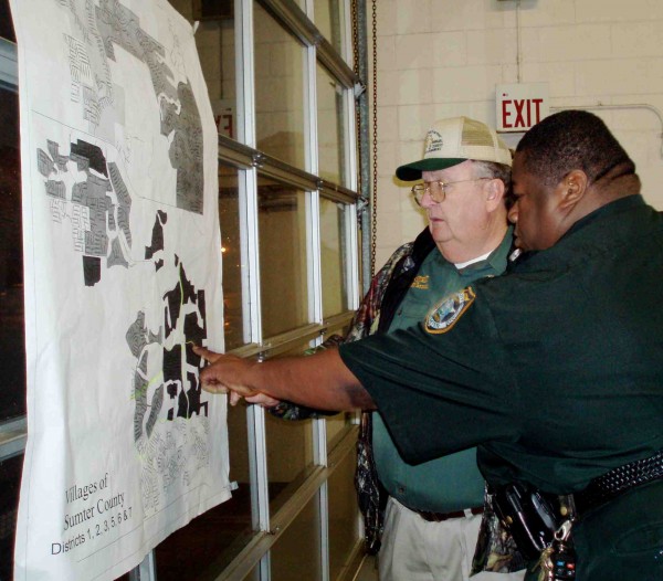 Lt. Nehemiah Wolfe points to a map of The Village to show Sheriff Farmer where the brunt of damage occurred in the Ground Hog Day Tornado.