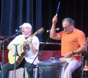 Rocky plays the garbage can while Bruce Wallace sings.