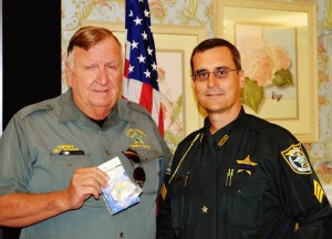 Sheriff Bill Farmer, left, presents Lt. Robert Siemer with his new badge.