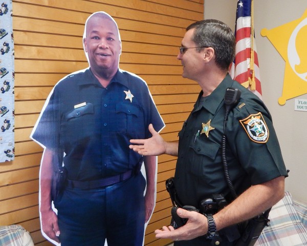 Lt. Robert Siemer jokes with a life-size cutout of Lt. Nehemiah Wolfe who recently retired.