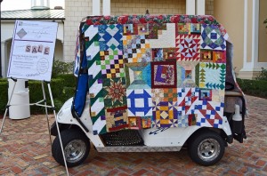 A golf cart covered in quilts at the entrance to Savannah Center.