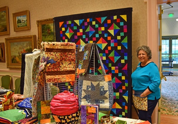 Ester Meinhardt of the Piecemakers Chapter of the Guild, showing off her quilts