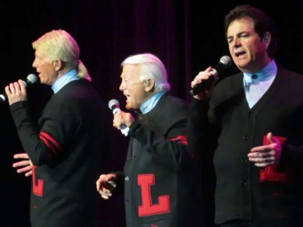 The Lettermen on stage in their black sweaters.