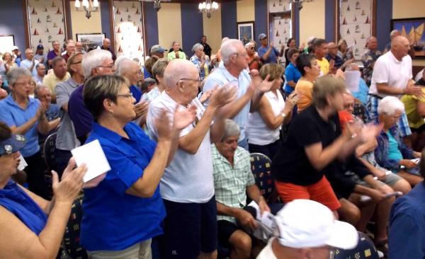The crowd breaks out in applause as a resident calls on supervisors to reject side striping in CDD 8.