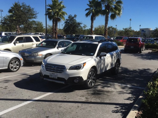 A car takes up four spots outside Best Buy at the Villages Crossroads shopping center.