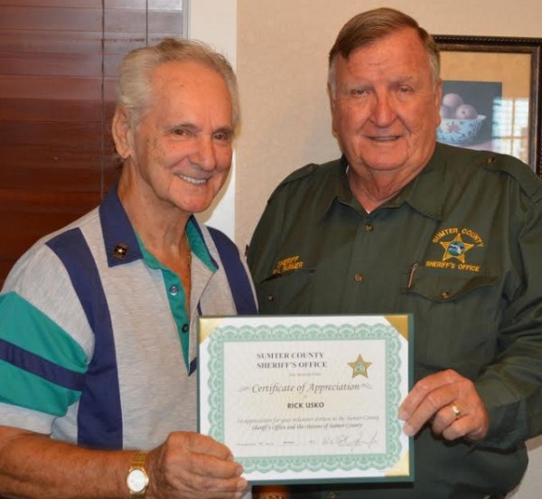 Rick Usko receives a certificate of apprecaition from the sheriff.