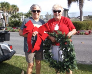 Bev Levens and Glenda Wolfe. from left, were decorating in the Village of Gilchrist.