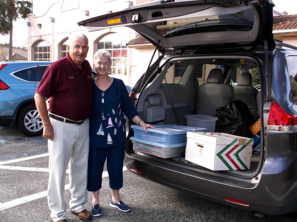 Carol Moseman gets a little help unloading decorations from Sumter County Sheriff's Office volunteer Tom St. Mary.