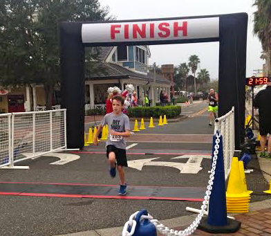 Ten-year-old Tanner Smith crosses the finish line.