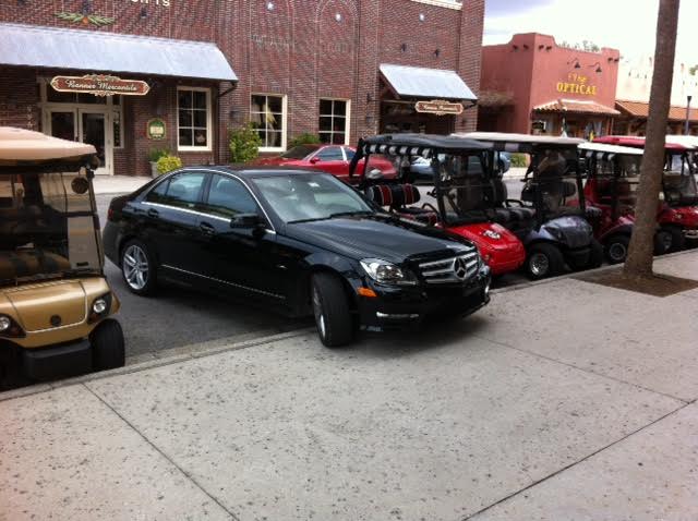 An automobile parked in a golf cart spot at Spanish Springs Town Square.