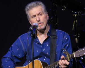 Johnny Rivers plays acoustic guitar.
