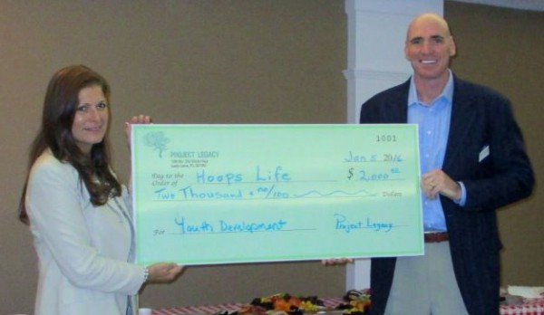 Pat Burke of HoopsLife accepts a $2,000 check from Project Legacy Board Secretary Karen Mercer.