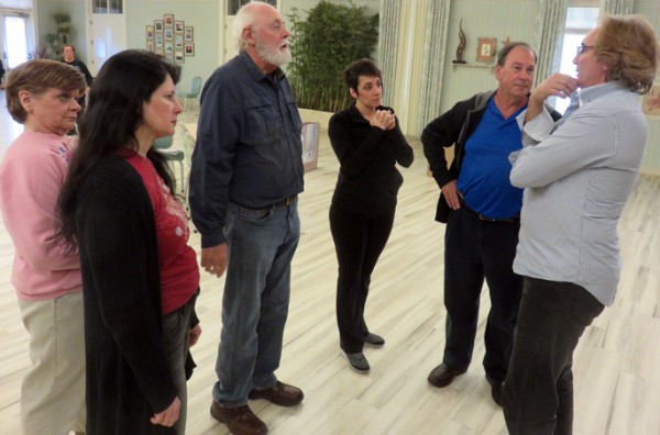 Alex Santoriello, right, gathers Man of La Mancha actors for a pep talk including from, left, Mia Reeves, Billie Thatcher, Dave Thoreson, Dawn DiNome and Tim Casey.