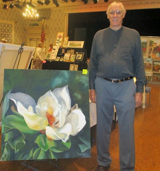 Artist Roger Sherman standing with his painting “Magnolias in Early Light.” He donated a GICLEE print to the Scholarship Fund.