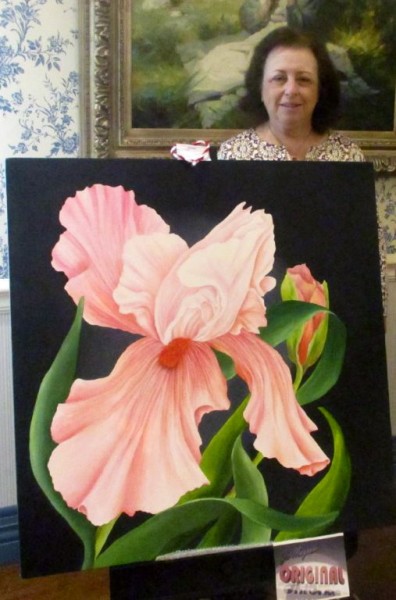 Jo Magrum, Art Show Committee Chair, standing with one of her paintings “Spring in Pink.” It is one of her favorites.