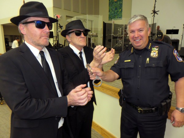 Lady Lake Police Chief Chris McKinstry nabs Rob left and John Skolits of the Blues Brothers Tribute Band.