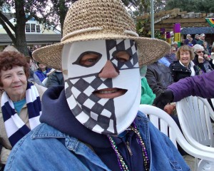 Lynn Griebahn of the Village of Del Mar shows off his homemade Mardi Gras mask.