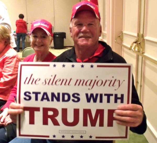Walt Farnsworth holds a sign in support of Donald Trump.