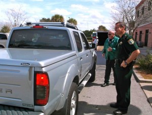Lt. Robert Siemer, right, chats with a Villager dropping off unused medicine at Operation Medicine Cabinet.