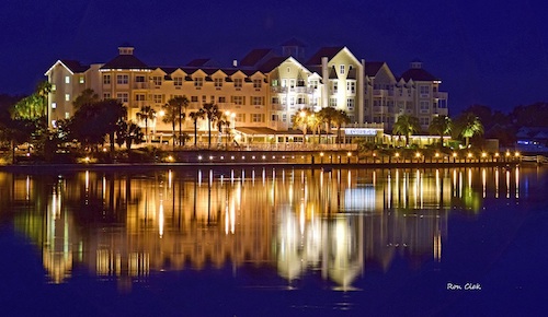 The Waterfront Inn at night on a calm Lake Sumter