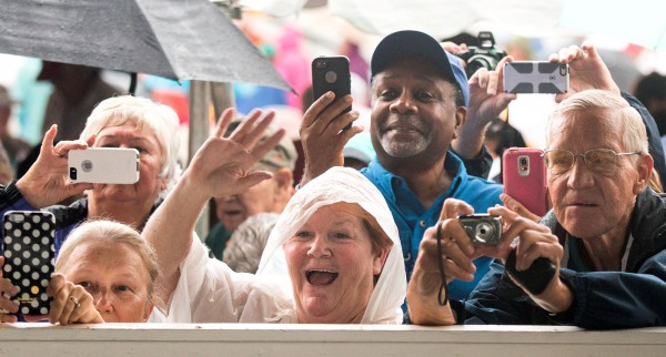 Eager fans take photos and wave to Wheel of Fortune star Vanna White during her appearance at Lake Sumter Landings in The Villages on Saturday, April 2, 2016. White was there to promote the Florida Lottery's new $5 Wheel of Fortune ticket that will go on sale next week. Photo by Tom Burton.