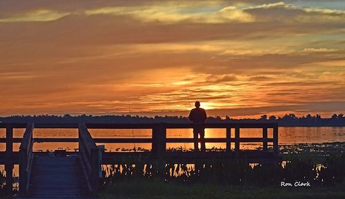 Villager Tom Gourlay fishing at sunrise on Lake Deaton