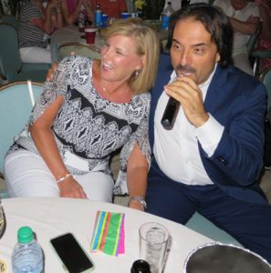 Franco Corso serenades Barbara Iannielli at her table.