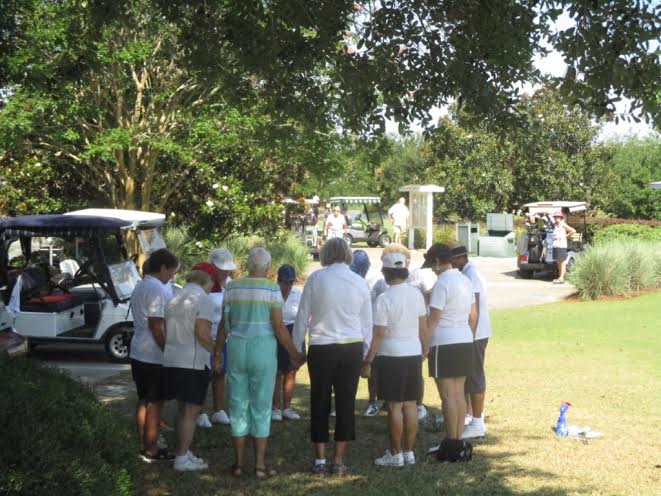 Members of the Northside Golf League says a prayer.