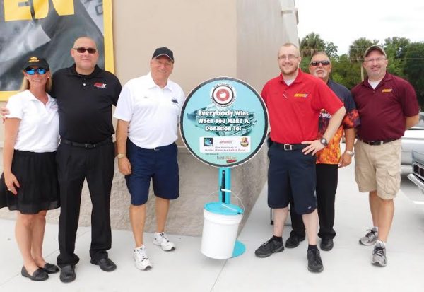 From left, Bridgett Barber Bishop, sales manager Advance Auto Parts; Mike McVay, District Manager; Alan Stone, Event Coordinator for TVAAC; Nick Williams, store manager, Scott Sakalo, local district manager, Frank Antonuccio, store manager in Lady Lake.